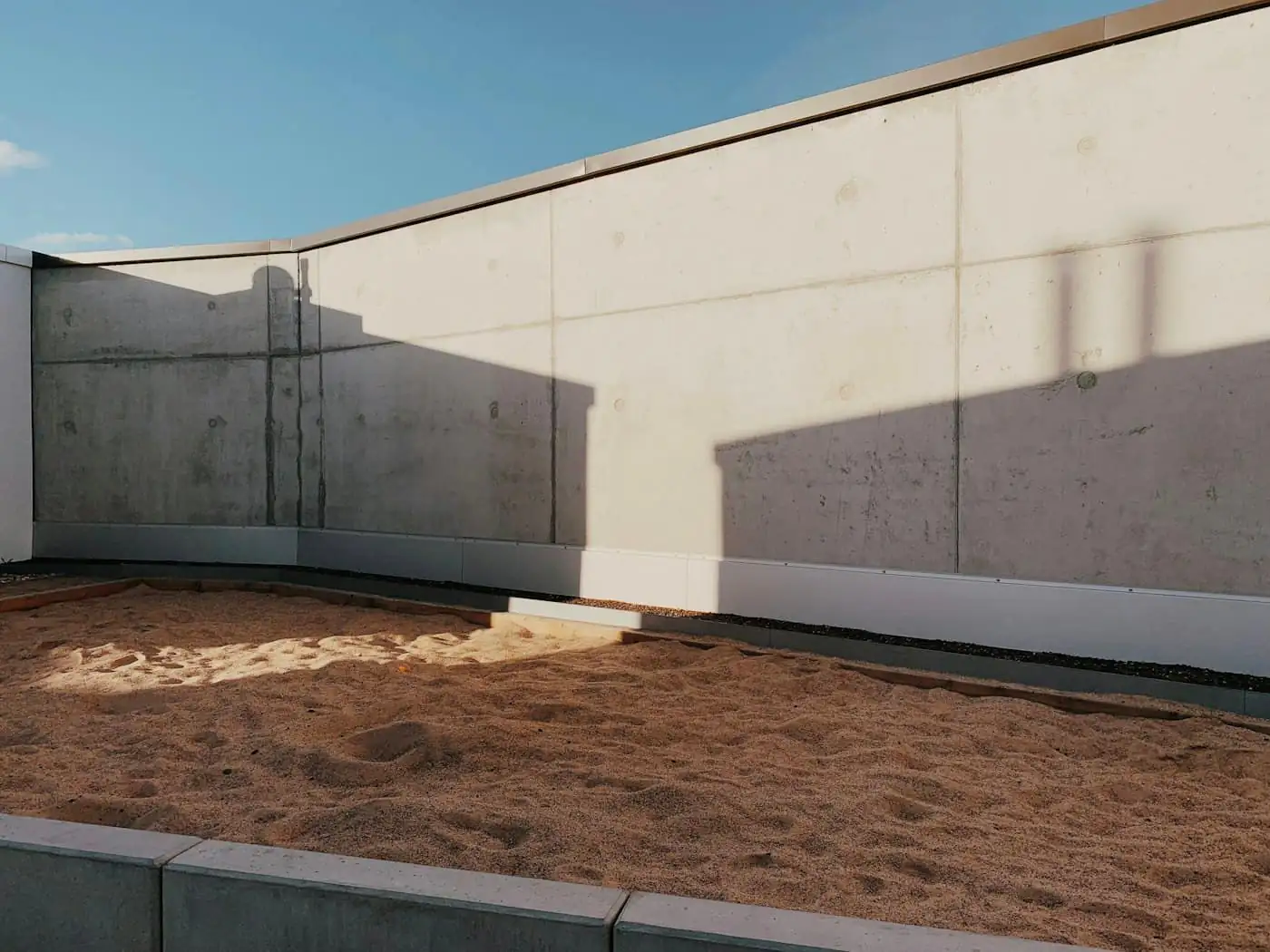Bare cemented backyard with a clothes line and no plants