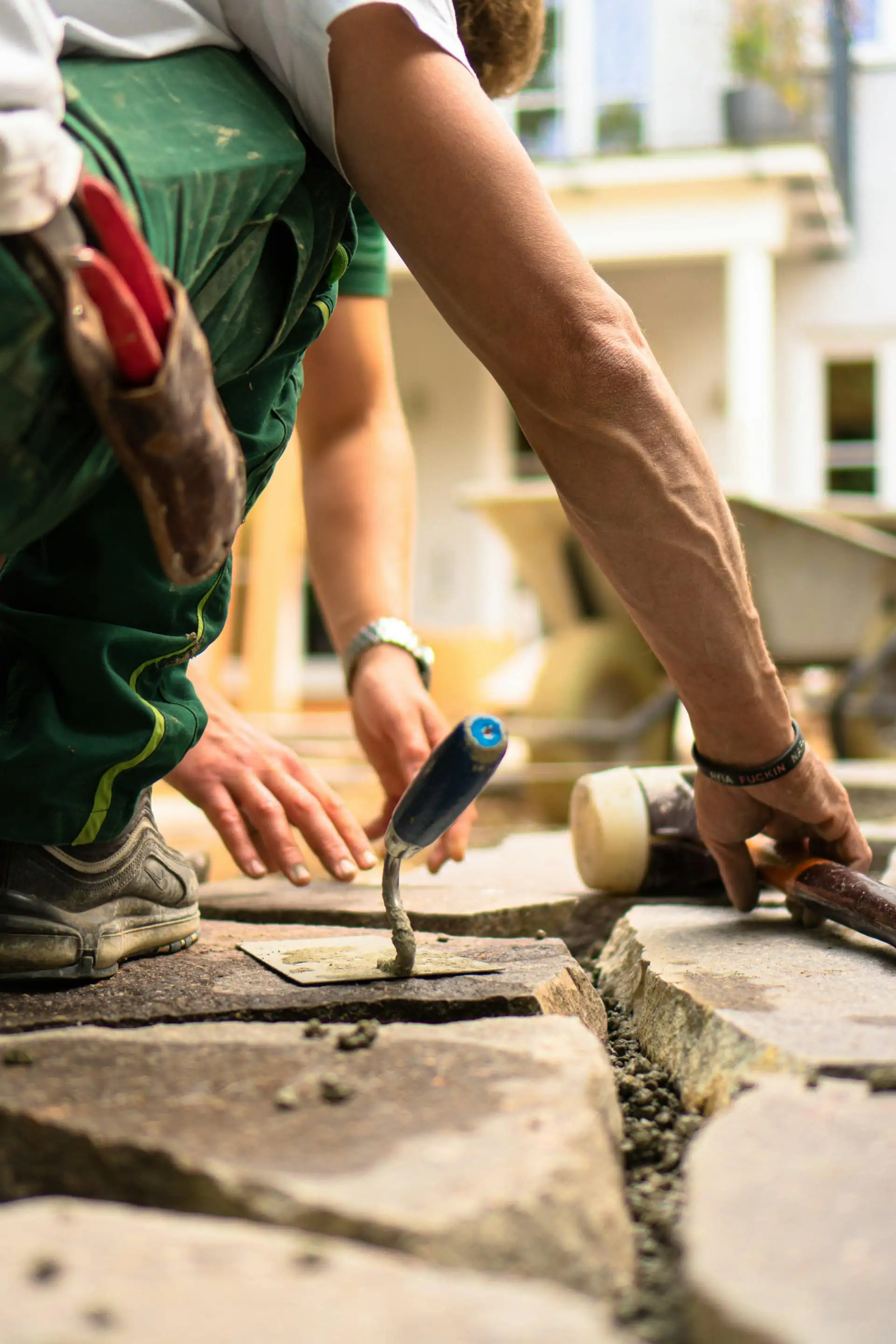 Landscaper laying natural stone paving